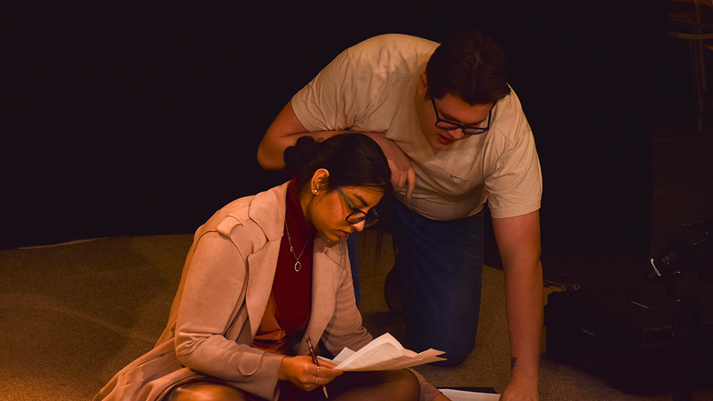 Thomas reviewing the script with producer Aisha Naushahi, on the set of Thomas’ honours project film, The White Room.